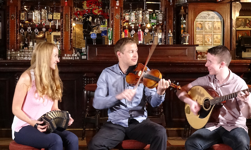 Caitlín Nic Gabhann (concertina and dance) and Ciarán Ó Maonaigh (fiddle) along with Cathal Ó Curráin (vocals, fiddle & bazouki) in a pub